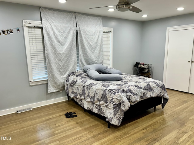 bedroom featuring wood finished floors, visible vents, and recessed lighting