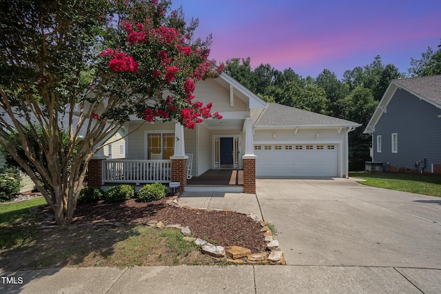 209 Homegate Cir, Apex, NC 27502 - view of front of house featuring an attached garage, covered porch, concrete driveway, and a shingled roof