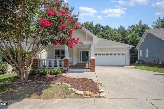 209 Homegate Cir, Apex, NC 27502 - view of front of property with an attached garage, covered porch, concrete driveway, and roof with shingles