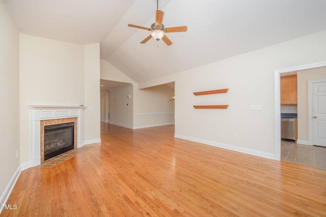 209 Homegate Cir, Apex, NC 27502 - unfurnished living room featuring a ceiling fan, light wood finished floors, a tiled fireplace, and lofted ceiling