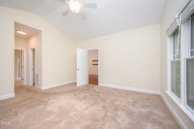 209 Homegate Cir, Apex, NC 27502 - empty room with light carpet, vaulted ceiling, a ceiling fan, and healthy amount of natural light