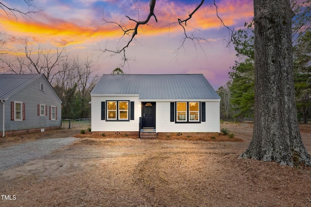 view of front of property featuring metal roof and crawl space