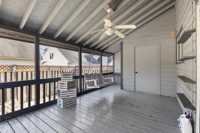 wooden terrace with ceiling fan and fence