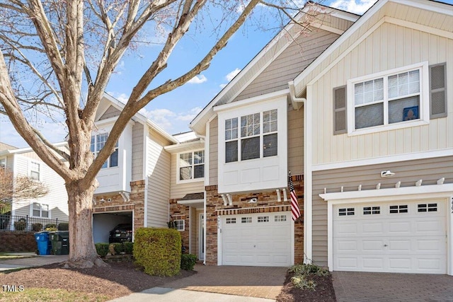 view of property featuring an attached garage and decorative driveway