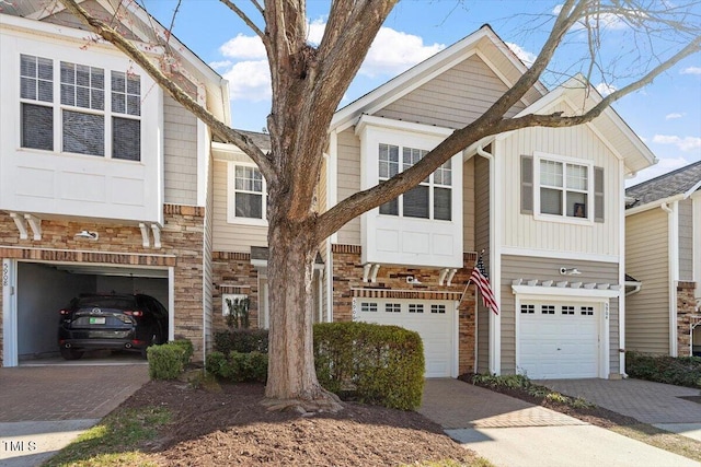 view of front of property featuring decorative driveway and an attached garage