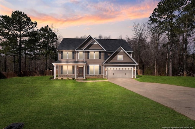 view of front facade featuring a garage, fence, a lawn, and concrete driveway