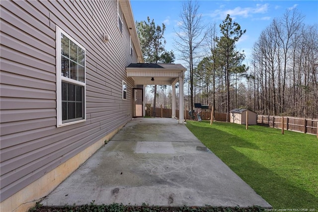 view of yard with a shed, an outdoor structure, and fence