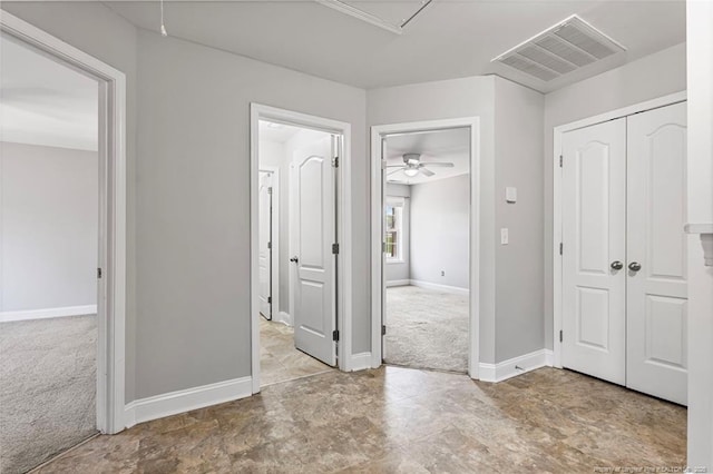 hall featuring visible vents, carpet flooring, attic access, and baseboards