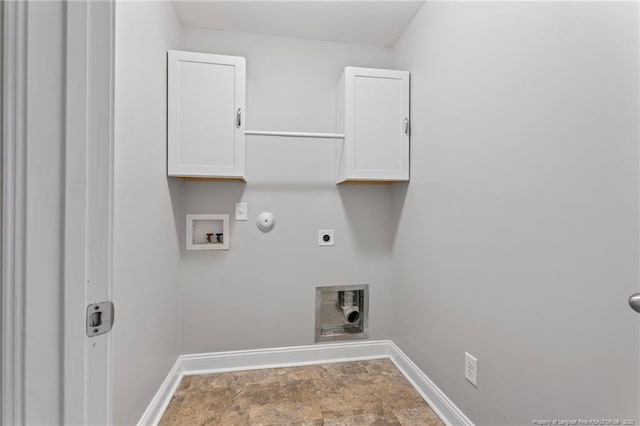 clothes washing area with hookup for a washing machine, hookup for a gas dryer, cabinet space, electric dryer hookup, and baseboards