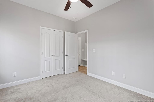 unfurnished bedroom featuring baseboards, ceiling fan, a closet, and carpet