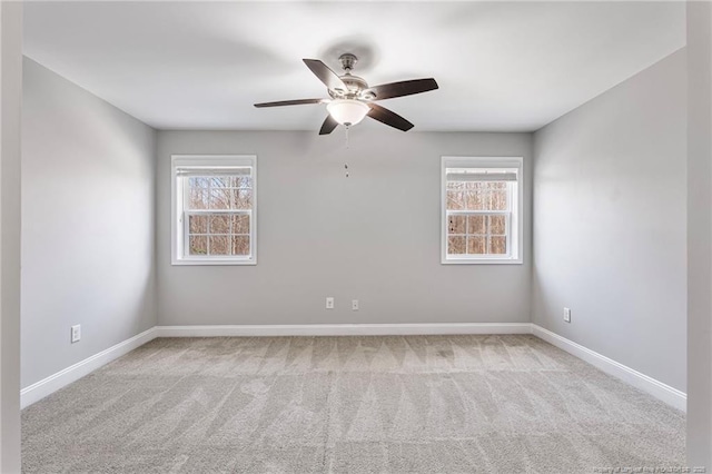 empty room featuring baseboards, a ceiling fan, and carpet floors