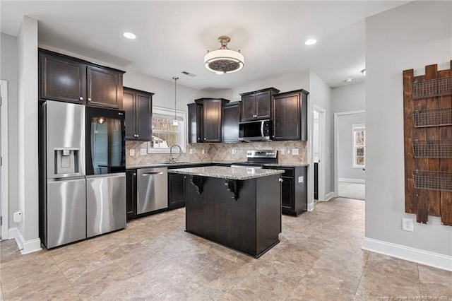 803 Equestrian Way, Raeford, NC 28376 - kitchen featuring appliances with stainless steel finishes, tasteful backsplash, a sink, light stone countertops, and baseboards
