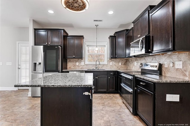 803 Equestrian Way, Raeford, NC 28376 - kitchen with stainless steel appliances, a sink, light stone counters, decorative backsplash, and recessed lighting