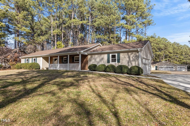 ranch-style house featuring covered porch, brick siding, and a front yard