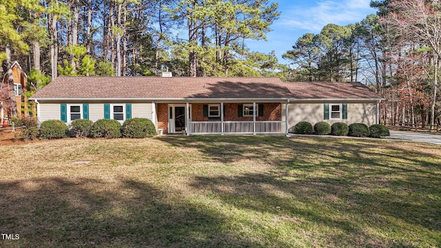 ranch-style house with a chimney, a front lawn, a porch, and brick siding