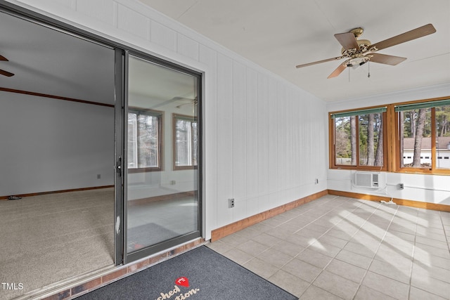 unfurnished sunroom with a wall mounted air conditioner and a ceiling fan