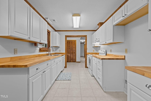 kitchen with butcher block counters, white cabinets, a sink, white appliances, and under cabinet range hood