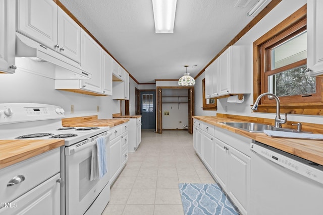 kitchen featuring under cabinet range hood, white appliances, butcher block counters, a sink, and white cabinets