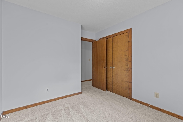 unfurnished room with carpet flooring and baseboards