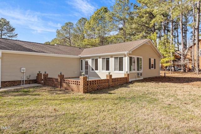 back of property featuring a patio area, roof with shingles, and a yard