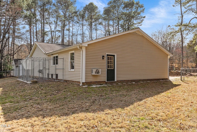 view of property exterior with fence and a yard