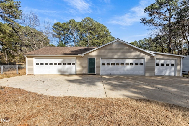 ranch-style home featuring fence, concrete driveway, and an outdoor structure