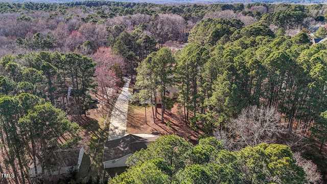 birds eye view of property featuring a view of trees