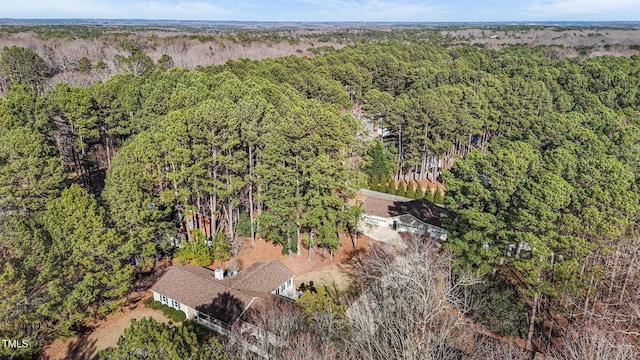 birds eye view of property featuring a wooded view