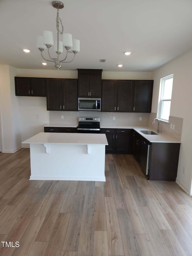 28 Longdale Dr, Graham, NC 27253 - kitchen featuring stainless steel microwave, range with electric cooktop, recessed lighting, light countertops, and light wood finished floors