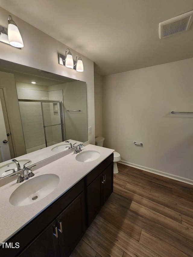 28 Longdale Dr, Graham, NC 27253 - bathroom with a stall shower, double vanity, and wood finished floors