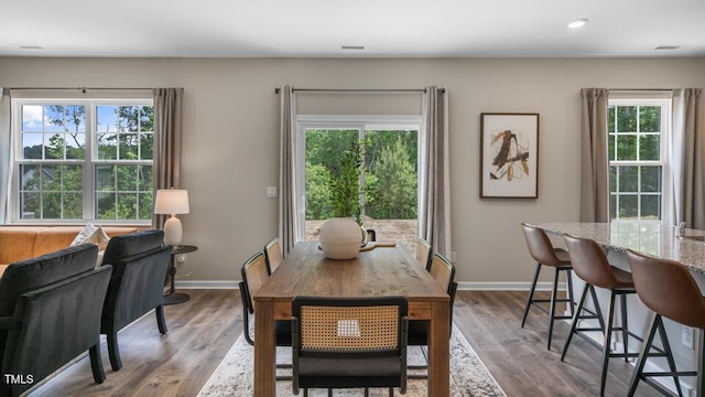 dining space featuring dark wood-style floors and baseboards