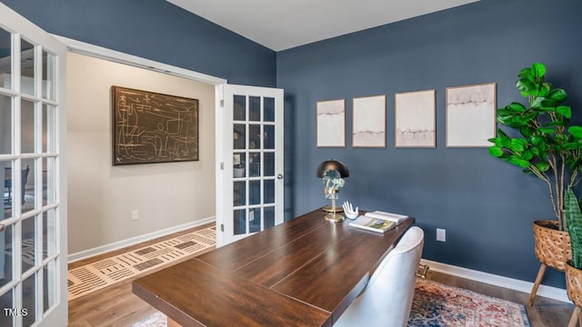 office space with french doors, wood finished floors, and baseboards