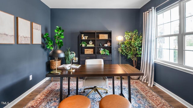 office area featuring baseboards and wood finished floors