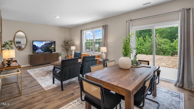 dining room with baseboards, visible vents, and wood finished floors