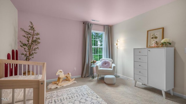 carpeted bedroom featuring baseboards and visible vents