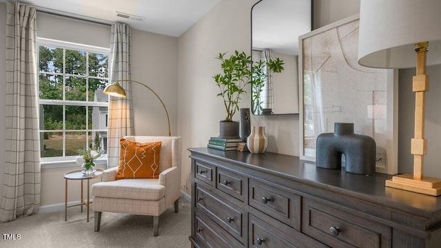 sitting room featuring plenty of natural light, carpet flooring, visible vents, and baseboards