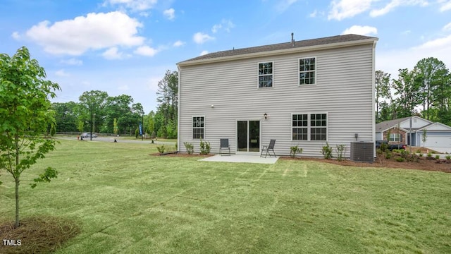 back of house featuring a patio area, a lawn, and central AC