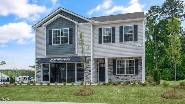 view of front of house featuring stone siding and a front lawn