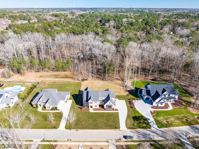 drone / aerial view with a wooded view