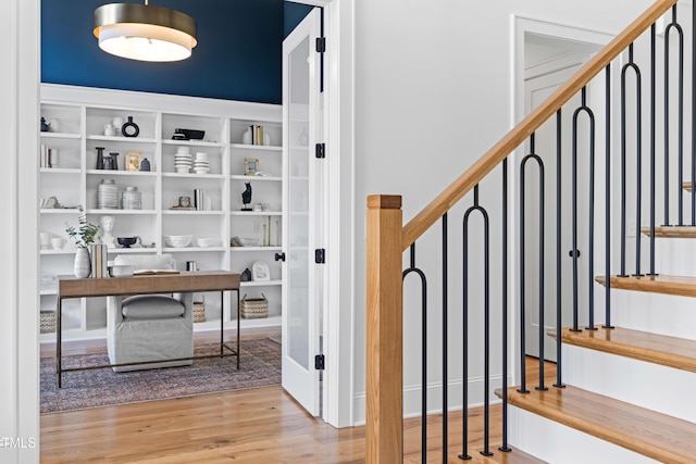 stairway featuring wood finished floors