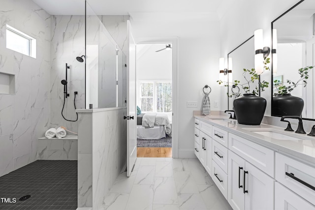 full bathroom with ensuite bathroom, a sink, marble finish floor, a marble finish shower, and double vanity