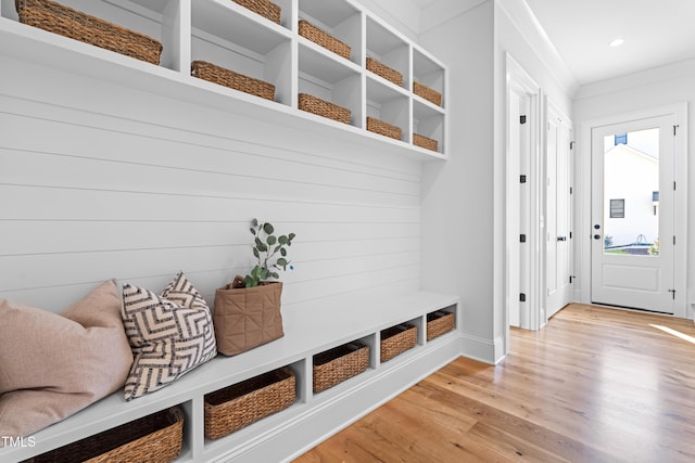 mudroom with light wood-type flooring, crown molding, and recessed lighting