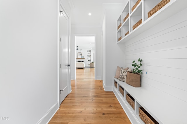 mudroom featuring recessed lighting, crown molding, light wood-style flooring, and baseboards