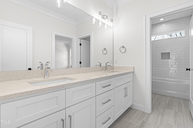 full bathroom featuring double vanity, a sink, and baseboards