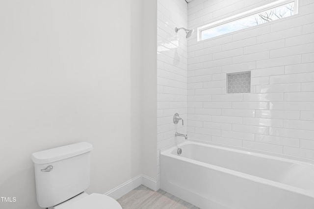 full bathroom featuring shower / bathing tub combination, toilet, and baseboards