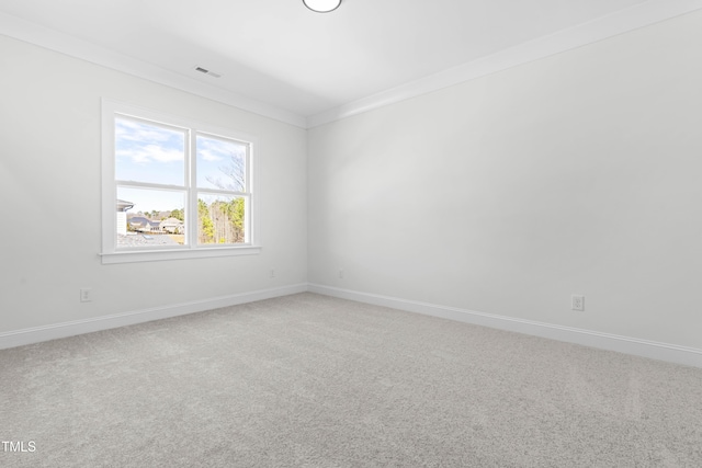 spare room featuring baseboards, visible vents, and light colored carpet