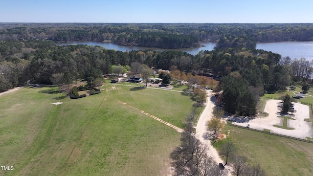 drone / aerial view featuring a water view and a wooded view