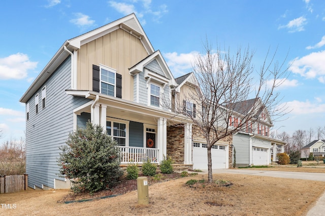 view of front of property featuring board and batten siding, concrete driveway, a porch, and a garage