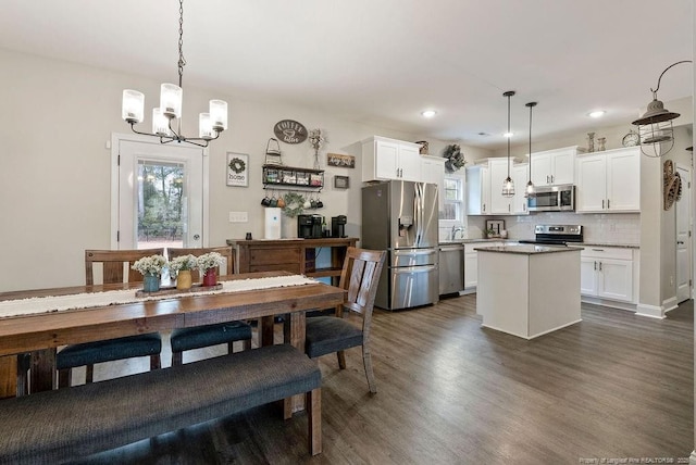 dining room featuring dark wood-style floors, recessed lighting, and a notable chandelier