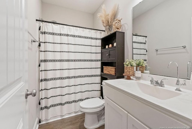 full bathroom with wood finished floors, shower / bath combo, vanity, and toilet